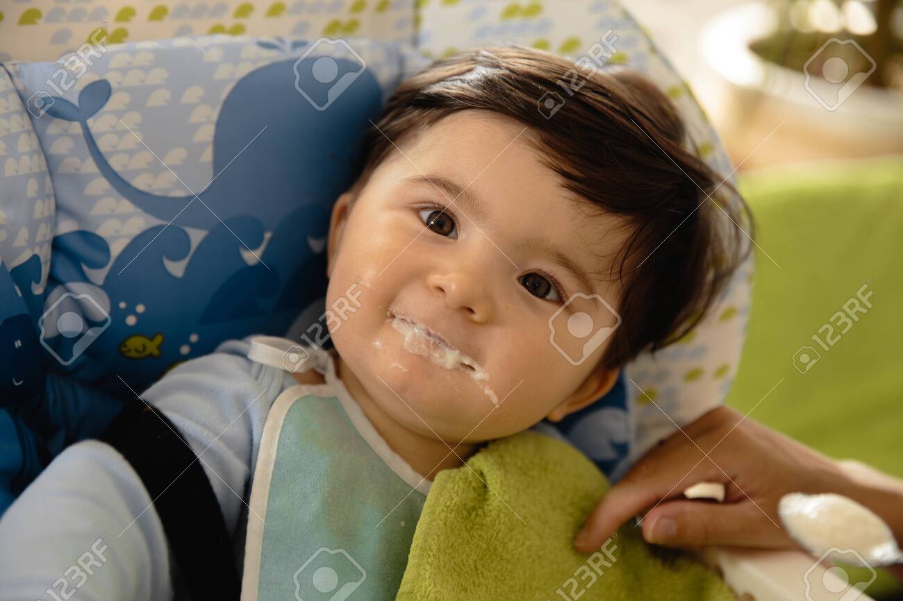 Mother Feeding Her Baby Son Porridge In The Child Seat Asian Stock Photo Picture And Royalty Free Image Image 130322090