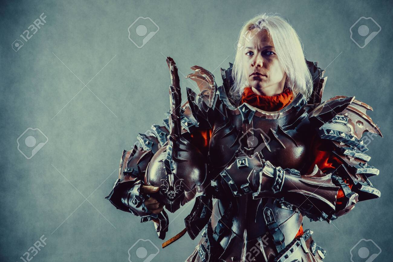 Portrait Of A Medieval Female Knight In Armor With Helmet In Hand Over Grey  Background. Stock Photo, Picture and Royalty Free Image. Image 154101058.