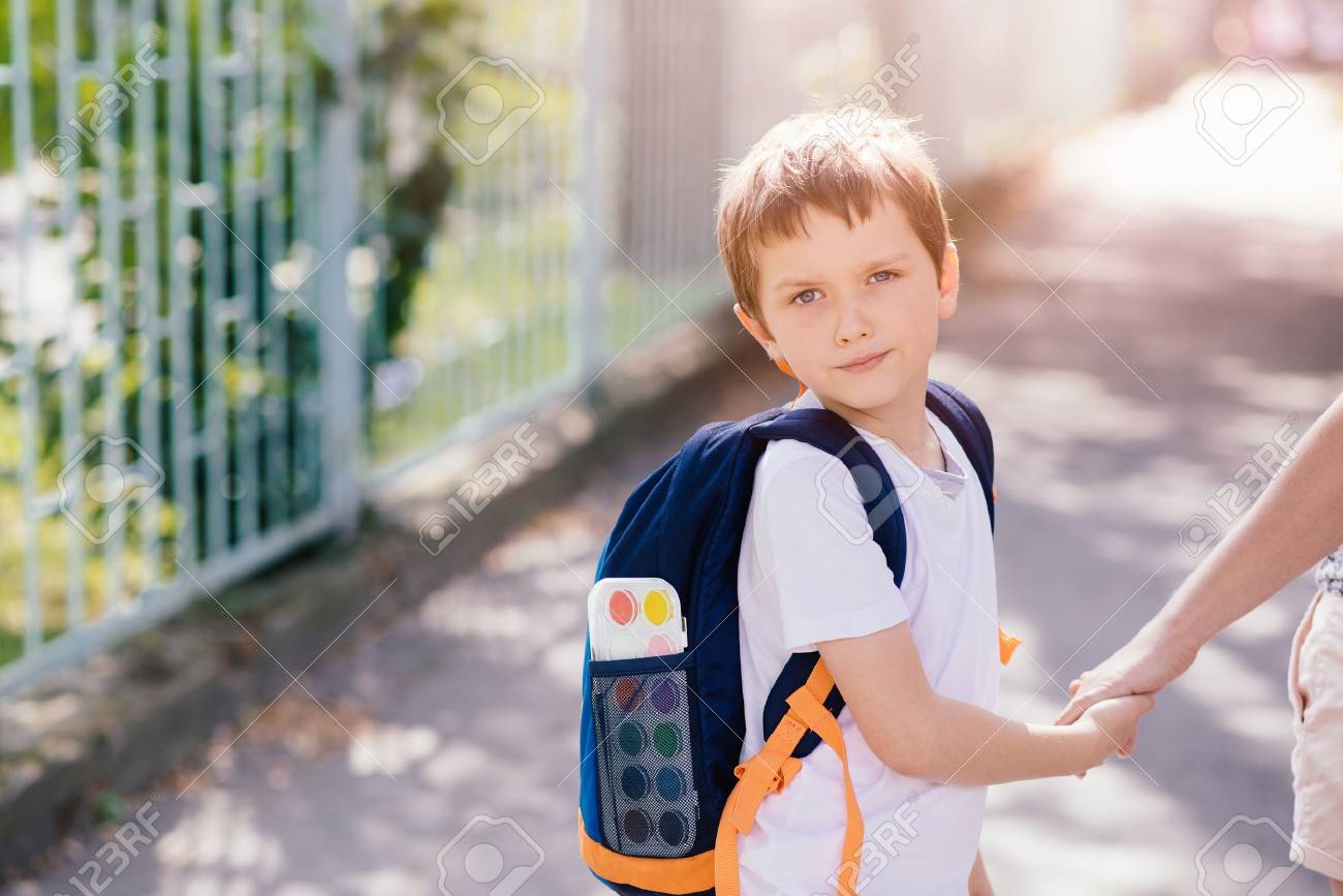 Little 7 years old boy going to school with his mother - 61929009 Little 7 years old boy going to school with his mother - 61929009