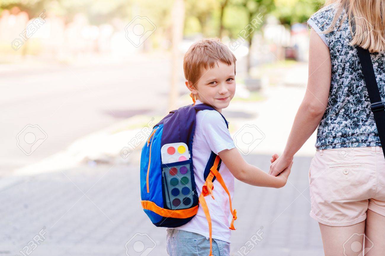 Little 7 years old boy going to school with his mother - 61929040 Little 7 years old boy going to school with his mother - 61929040