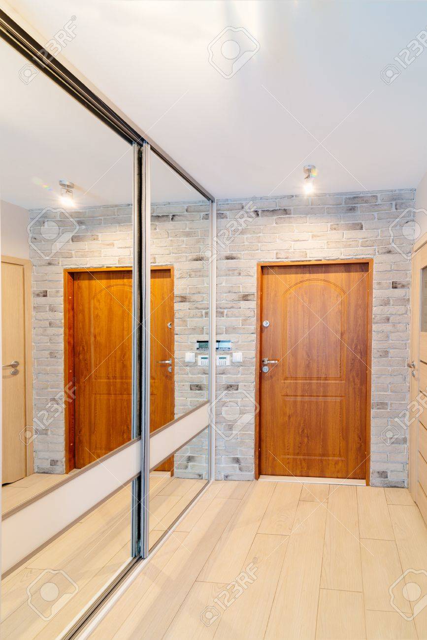Entrance Hall In Modern Apartment With Mirror Wardrobe With