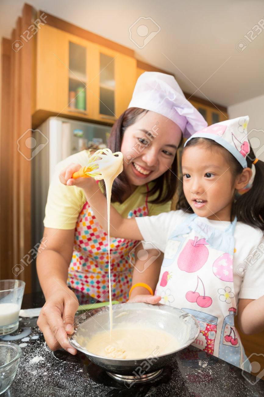 asian family enjoy making pancake asian mother and daughter stock