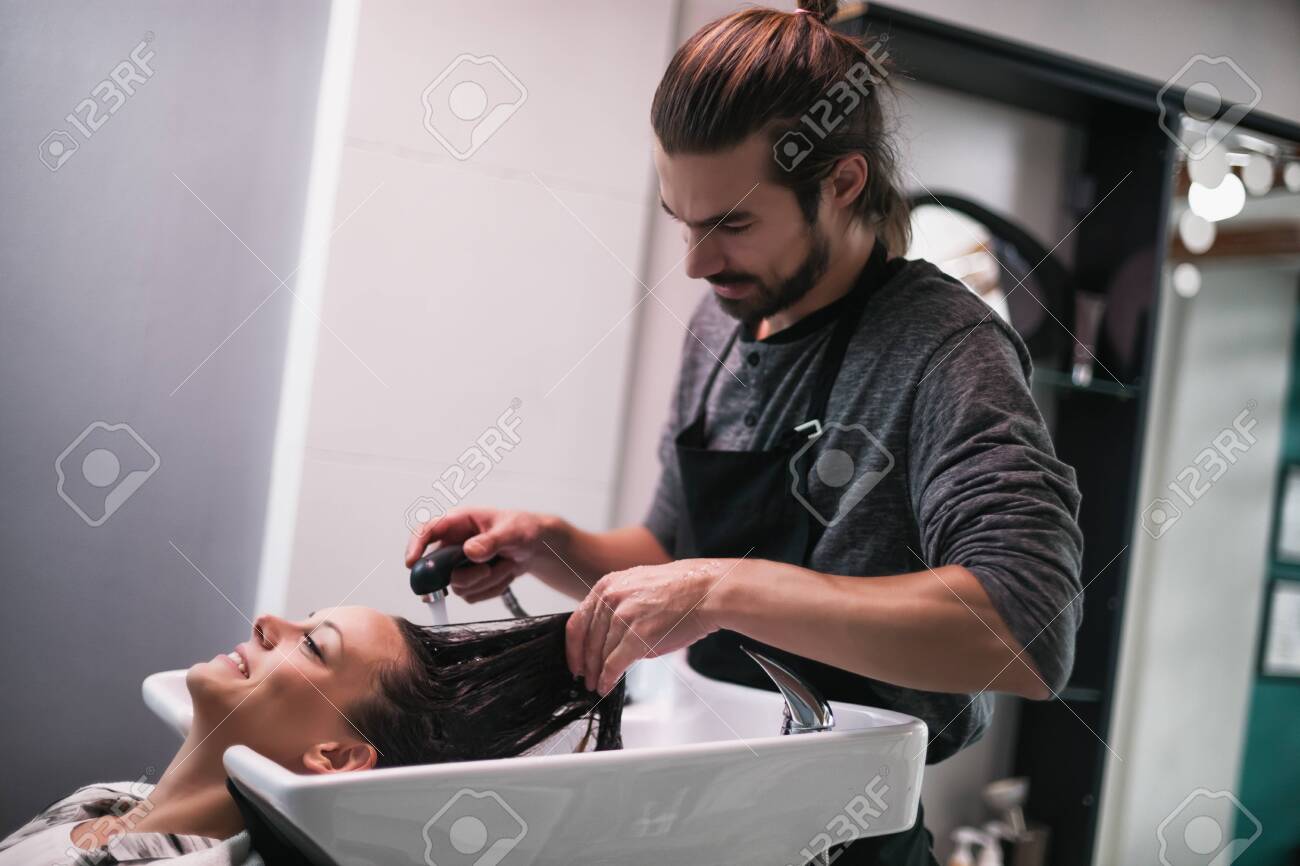 Young Woman Getting New Hairstyle At Professional Hair Styling