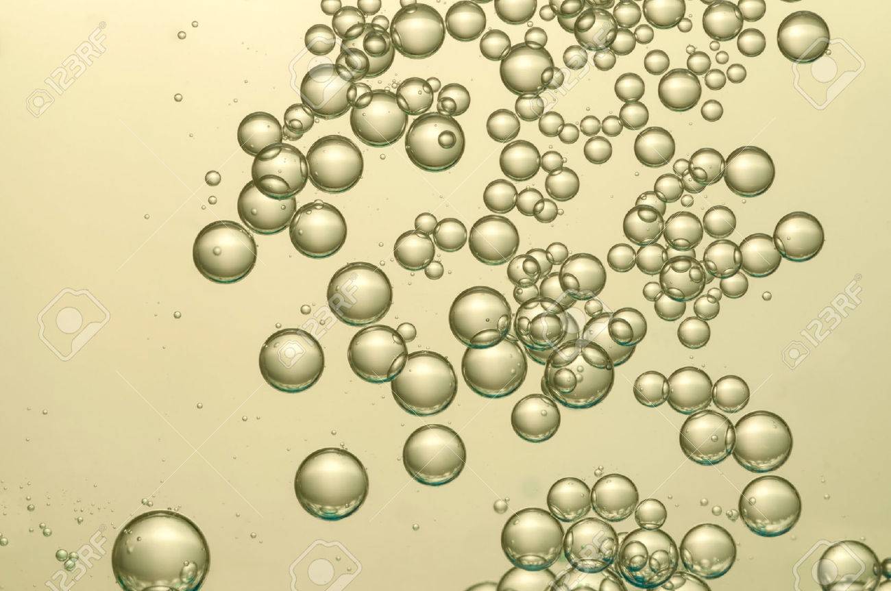 golden champagne bubbles float over a light background bubbles float