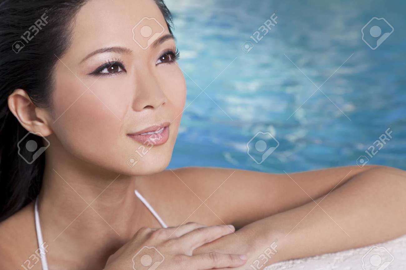 A Beautiful Young Chinese Asian Oriental Woman Wearing A Bikini And Relaxin...