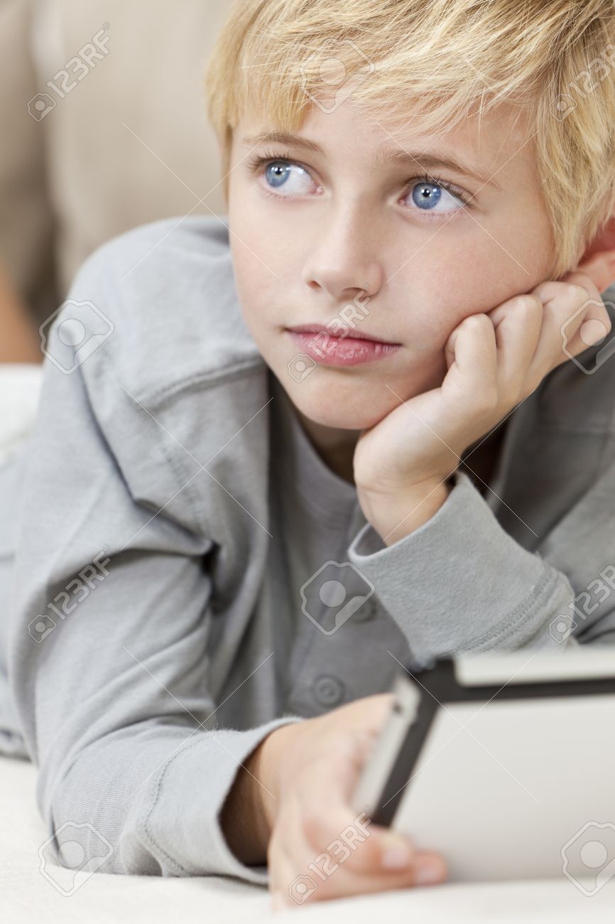 A Young Blond Haired Blue Eyed Boy Child Resting On His Hands