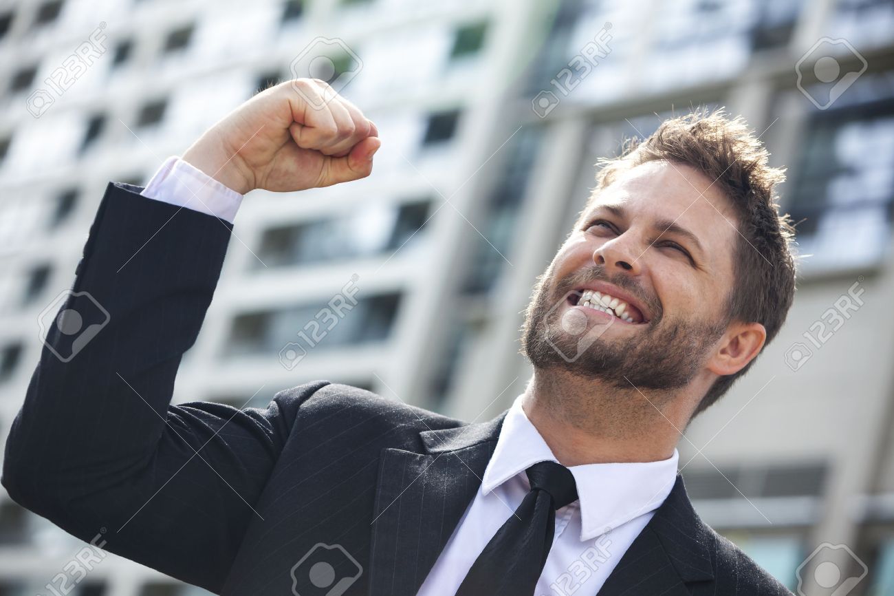 A Young Successful Man, Male Executive Businessman Arms Raised Celebrating  Cheering Shouting In Front Of A High Rise Office Block In A Modern City  Stock Photo, Picture And Royalty Free Image. Image
