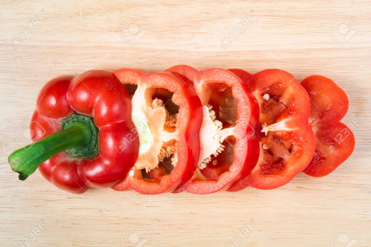 sliced red sweet pepper on a wooden block - 67147951 sliced red sweet pepper on a wooden block - 67147951