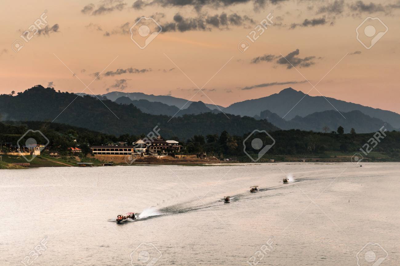 landscape view of great lagoon with four of boats downstream along a lagoon with a mountain behind in an evening. - 67339072 landscape view of great lagoon with four of boats downstream along a lagoon with a mountain behind in an evening. - 67339072