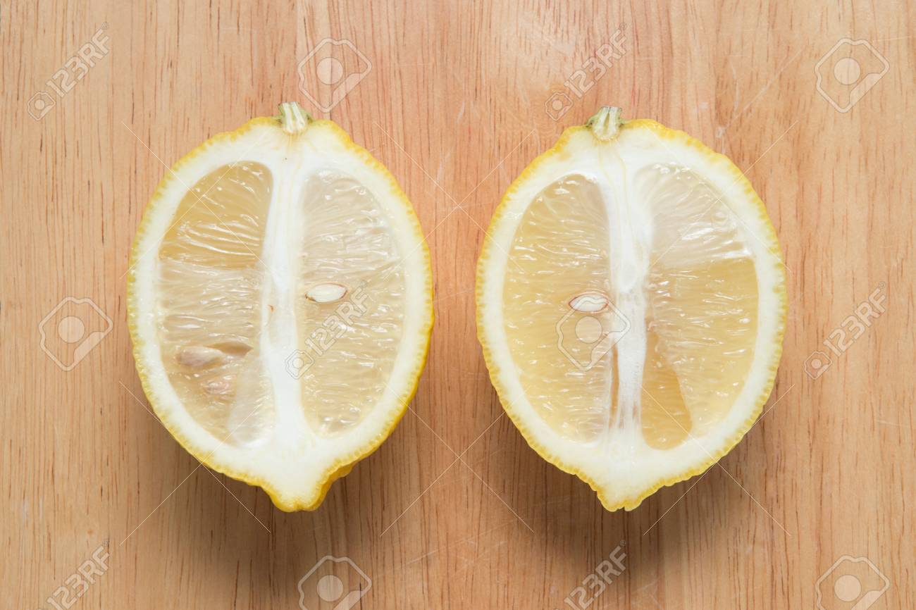sliced lemon fruit on a wooden block - 71400171 sliced lemon fruit on a wooden block - 71400171