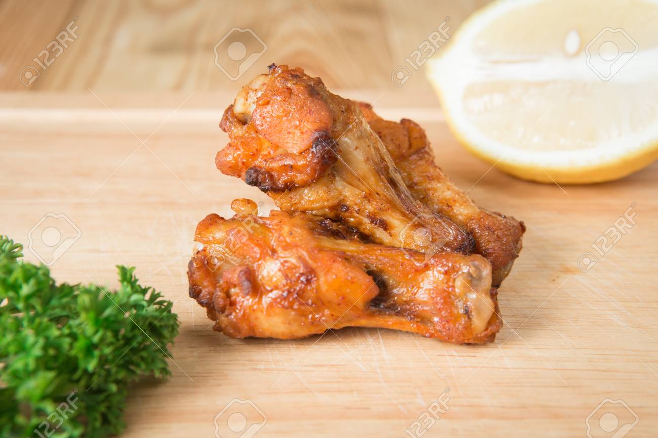Grilled chicken wing on a wooden block.(Selective focus) - 71330566 Grilled chicken wing on a wooden block.(Selective focus) - 71330566