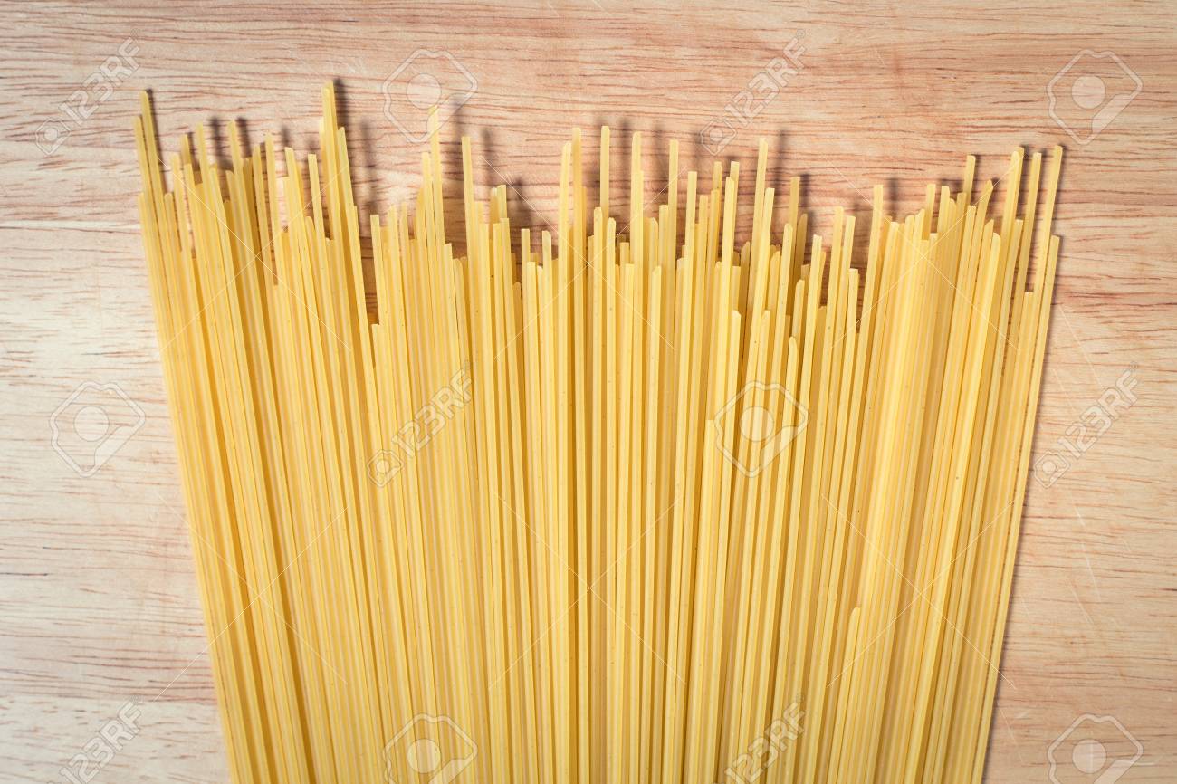 pile of raw spaghetti on a wooden block - 79022369 pile of raw spaghetti on a wooden block - 79022369