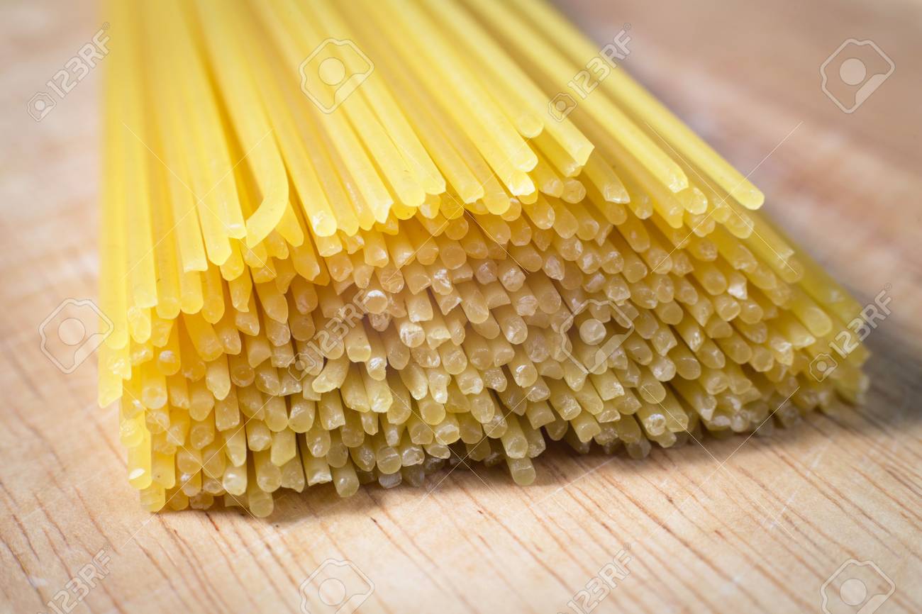pile of raw spaghetti on a wooden block - 79022370 pile of raw spaghetti on a wooden block - 79022370