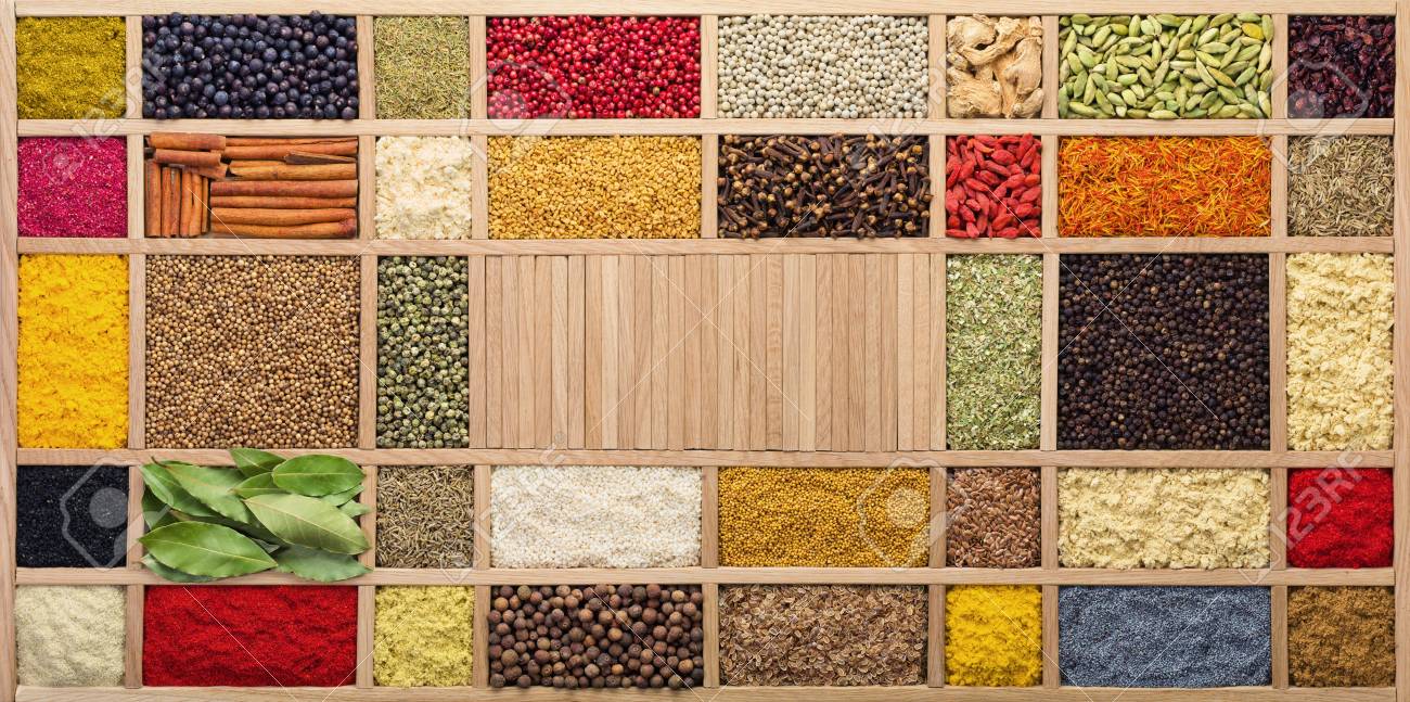 Spices and herbs in wooden box, top view. Seasonings from all over the world for cooking food. - 107310108 Spices and herbs in wooden box, top view. Seasonings from all over the world for cooking food. - 107310108