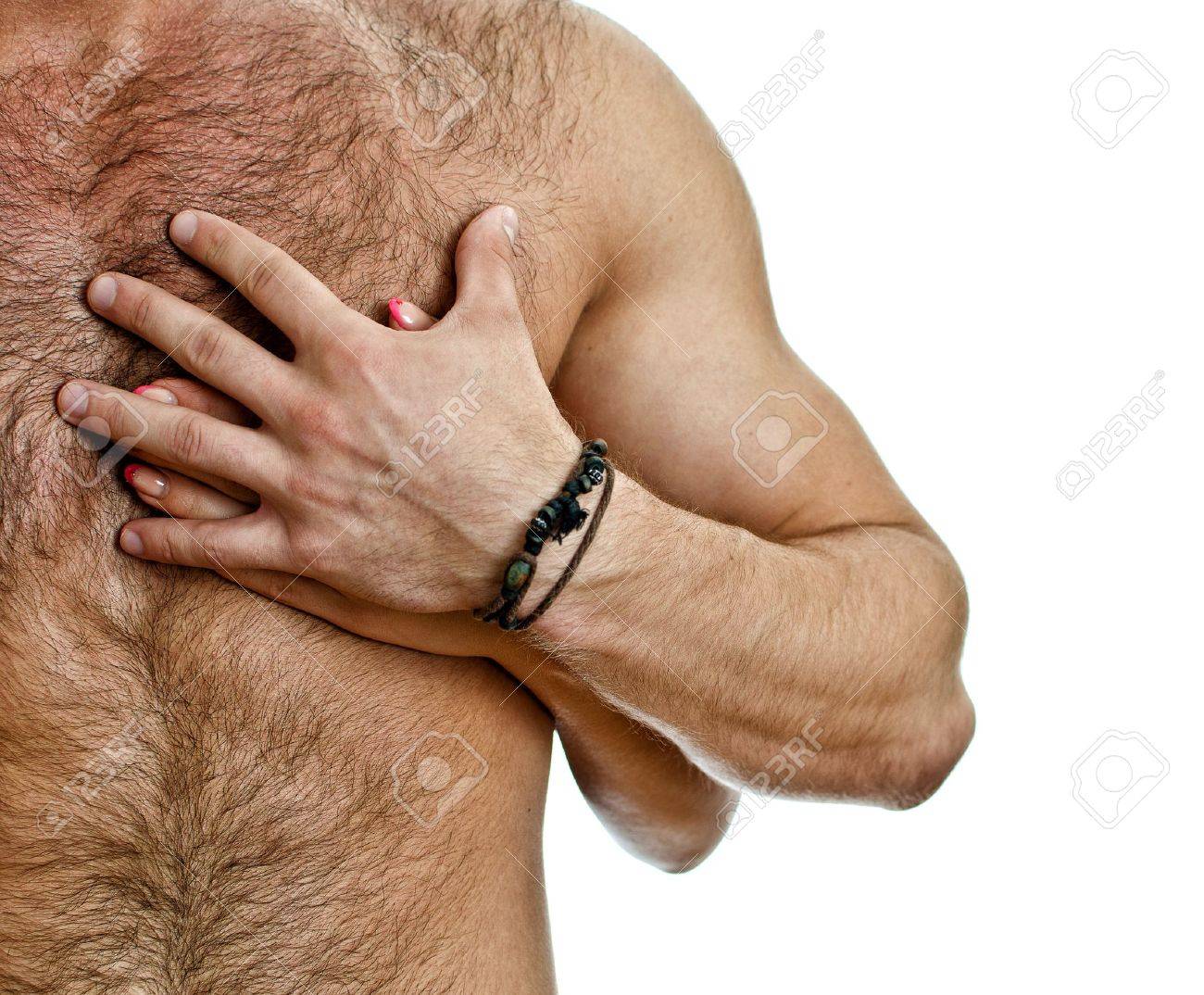 Female hand gripping a muscular male chest intimately