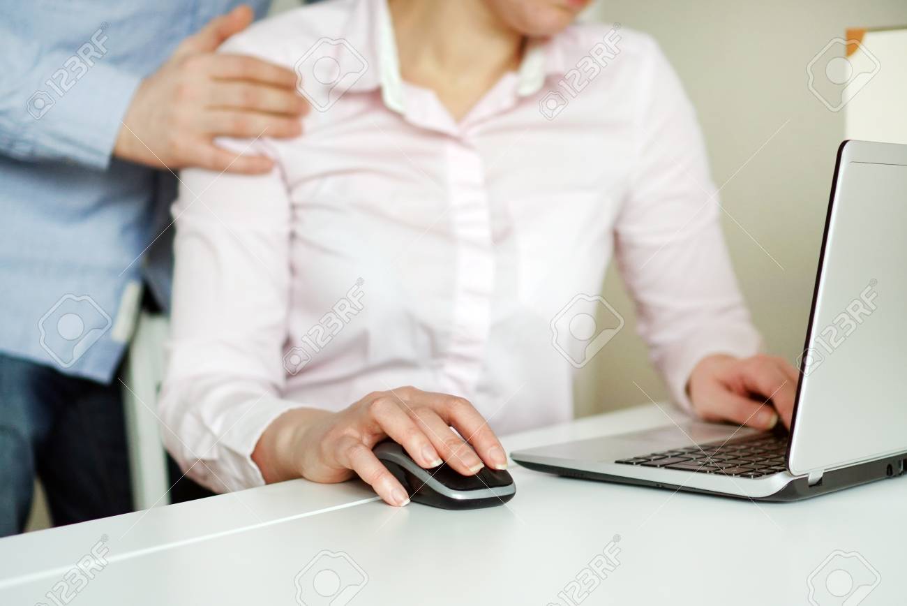 Sexual harassment at work. Man touching secretary's shoulder. - 97102892 Sexual harassment at work. Man touching secretary's shoulder. - 97102892