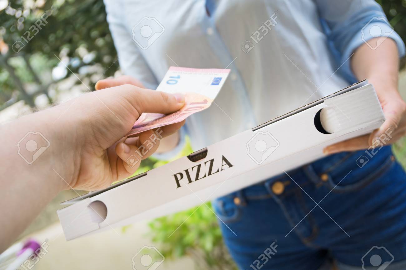 Woman delivering pizza in box and taking payment. - 109613957 Woman delivering pizza in box and taking payment. - 109613957