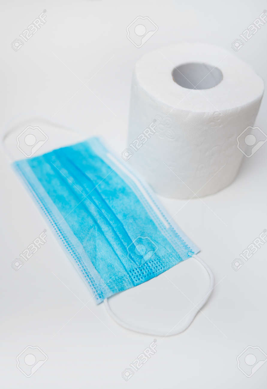 Toilet paper and medical mask. Coronavirus pandemic concept. - 146704292 Toilet paper and medical mask. Coronavirus pandemic concept. - 146704292