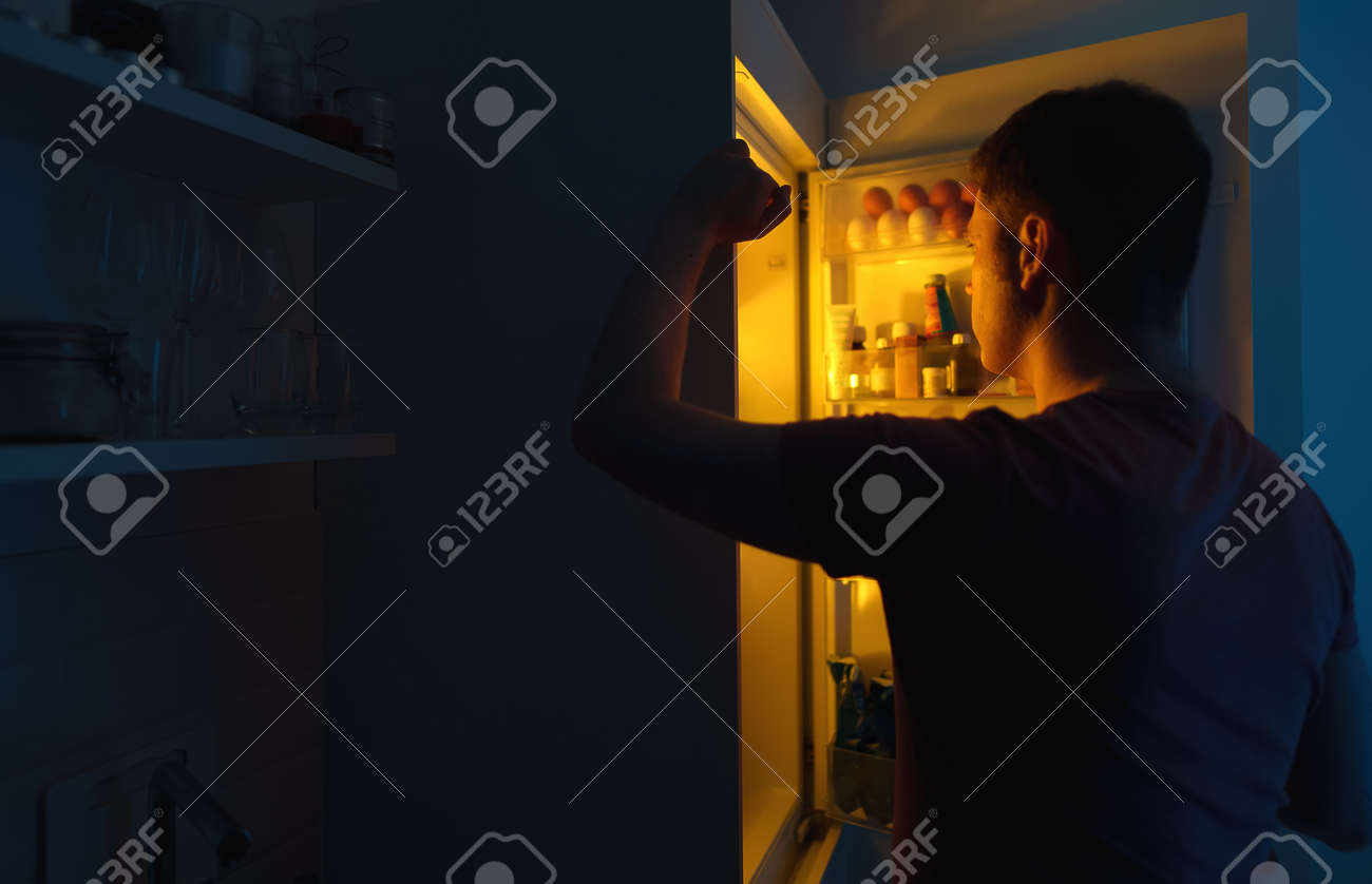 Man Looking For Food In Refrigerator At Night. Stock Photo, Picture and  Royalty Free Image. Image 164099359., image size:1300x838