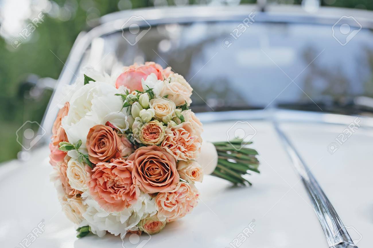 Wedding bouquet on the hood of a white retro car - 66577987 Wedding bouquet on the hood of a white retro car - 66577987