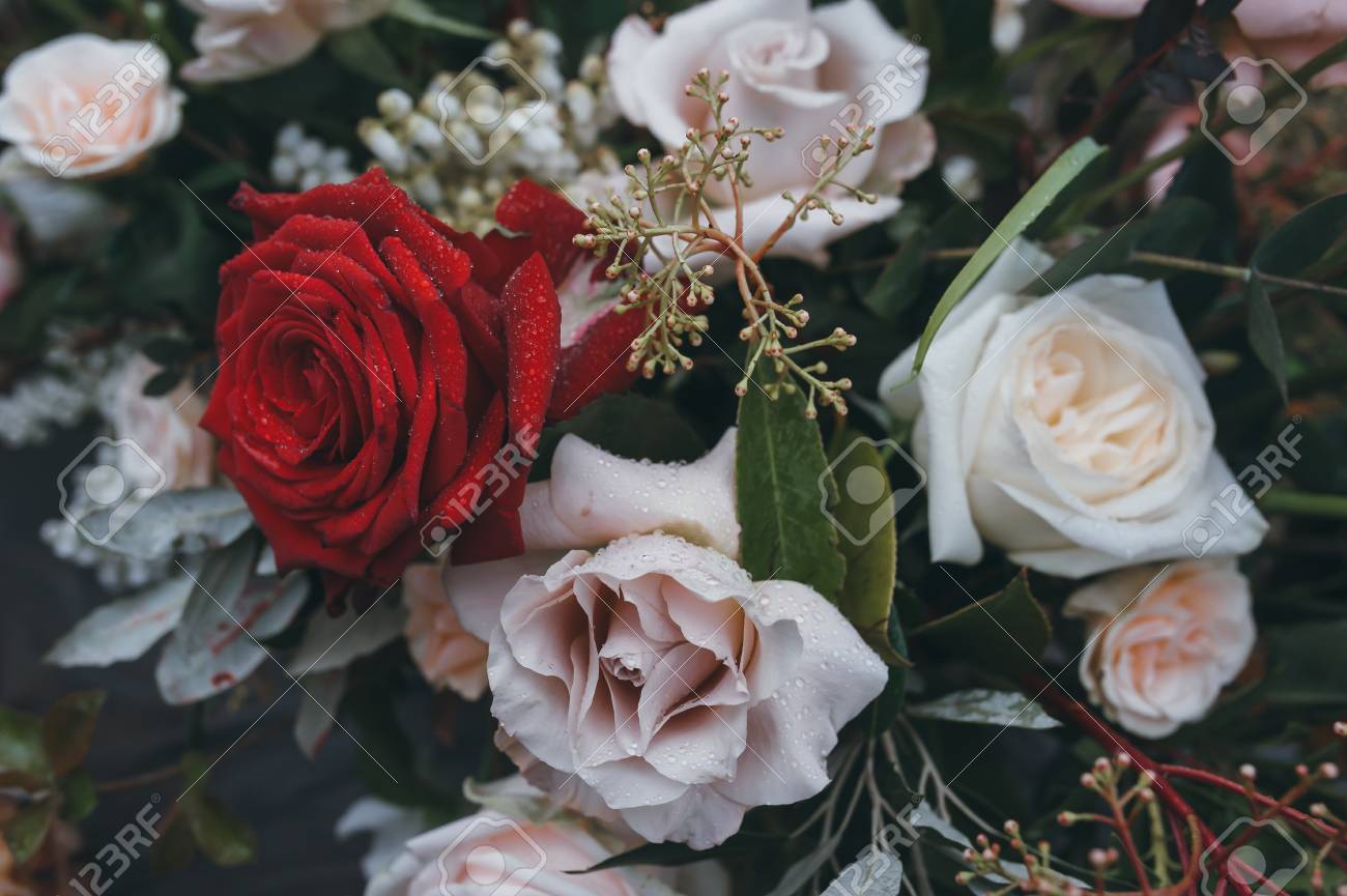 Wedding decorations. Bouquet of white and red flowers on a table..