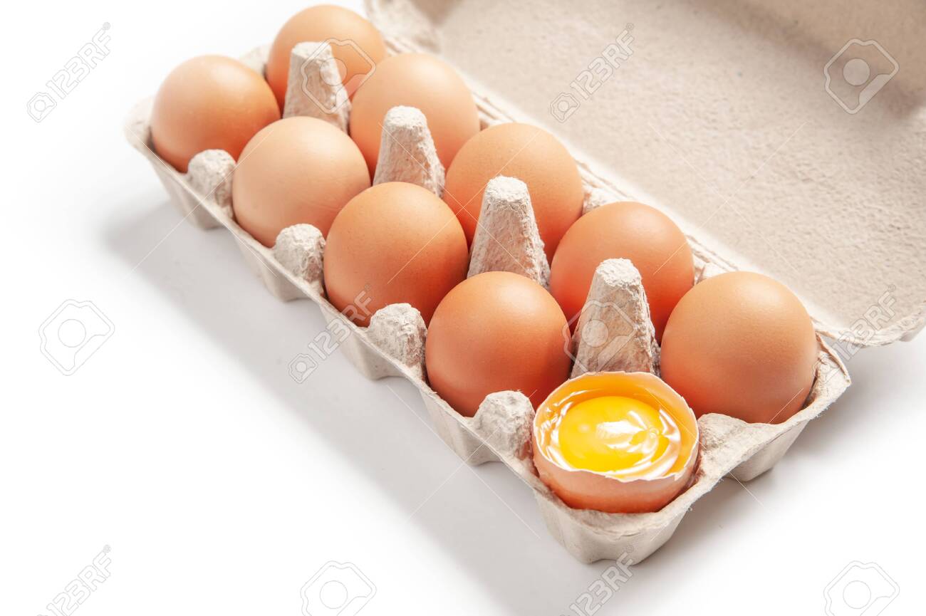 ten chicken eggs in a cage on a white background. isolated. one egg is opened - 145336683 ten chicken eggs in a cage on a white background. isolated. one egg is opened - 145336683