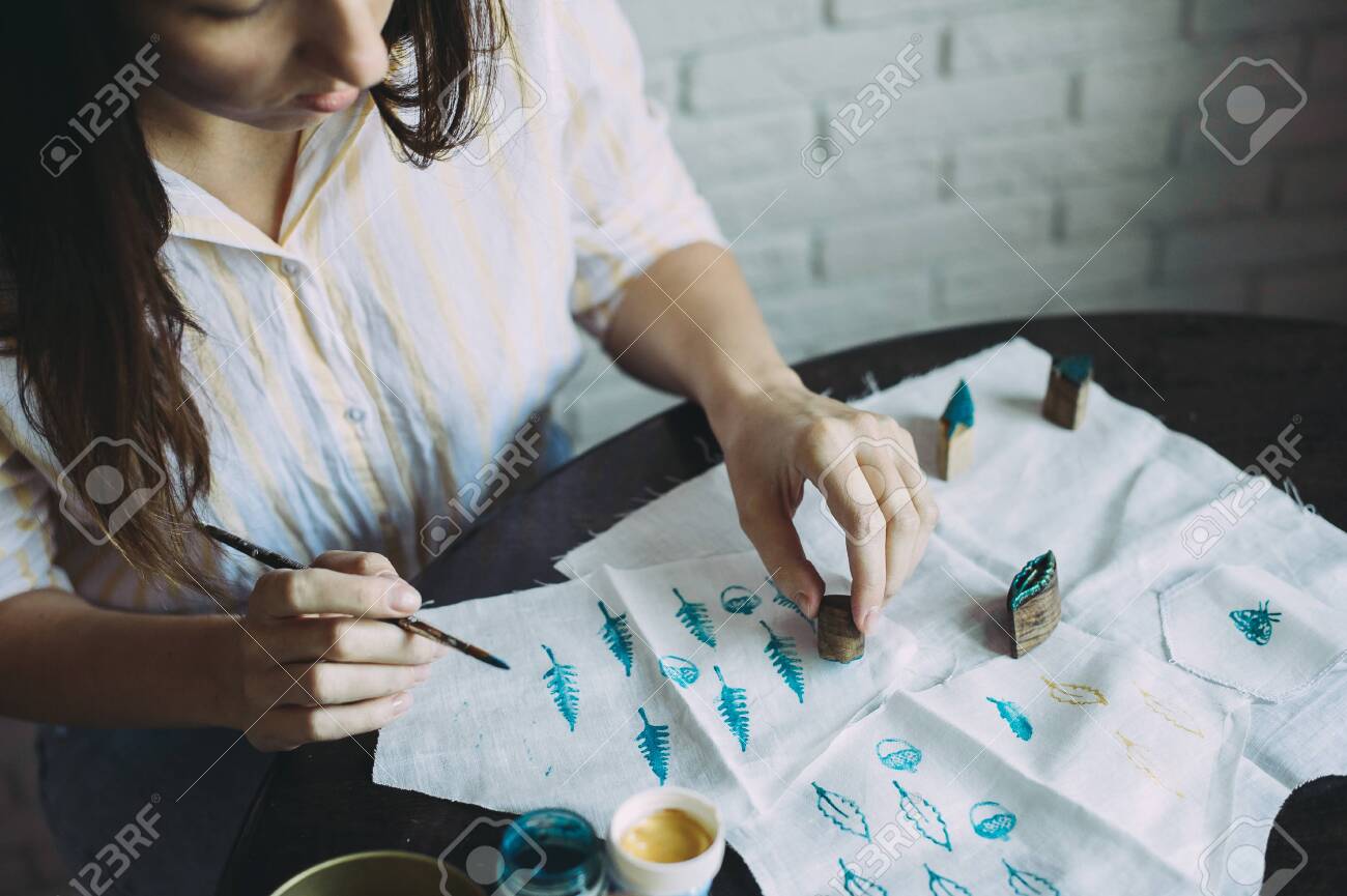 girl master makes stamps on the fabric. handmade - 145336858 girl master makes stamps on the fabric. handmade - 145336858