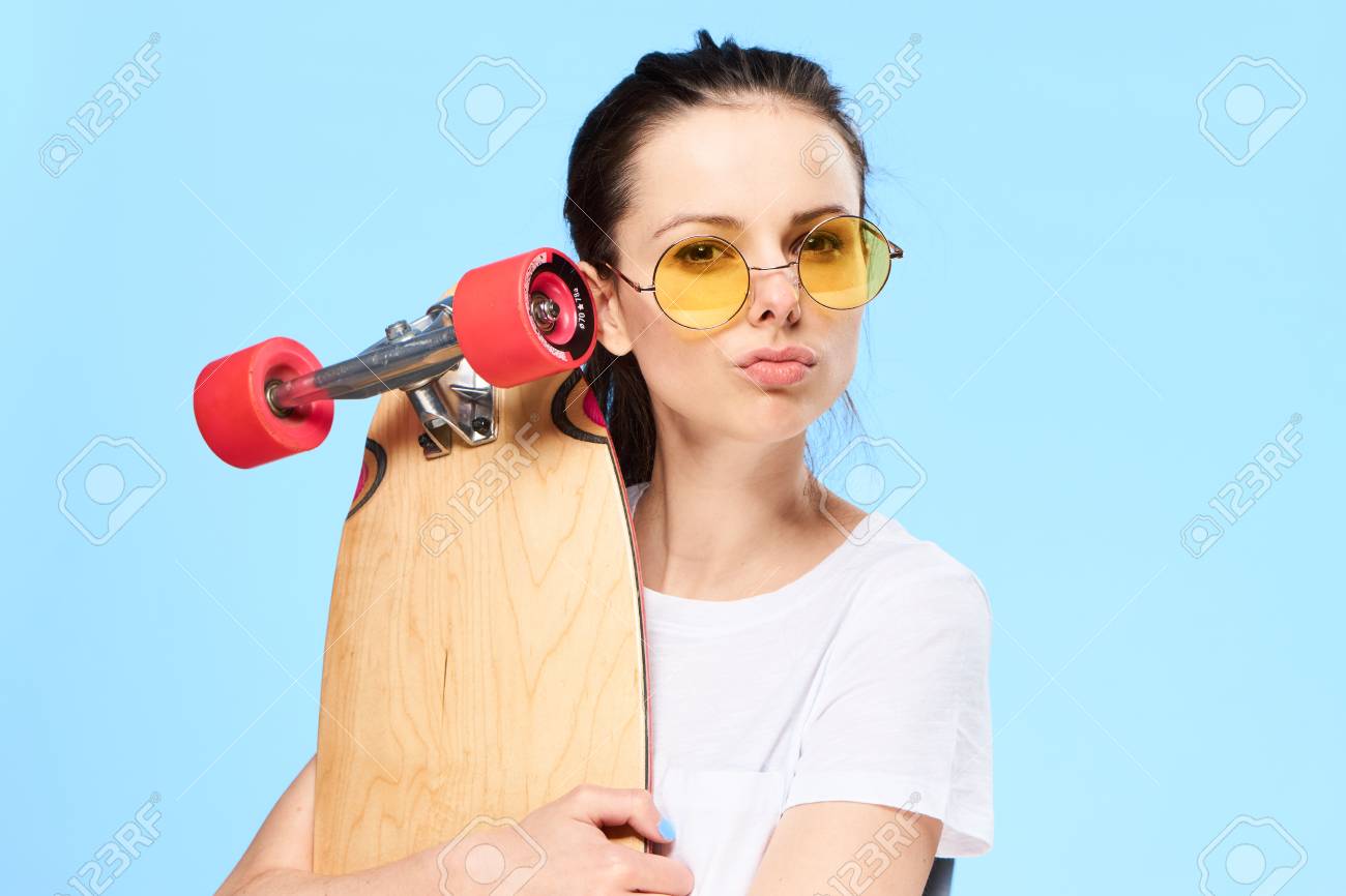 彼女の手でスケート ボードを持つ女性 スケート ボードとスタジオの女性 の写真素材 画像素材 Image