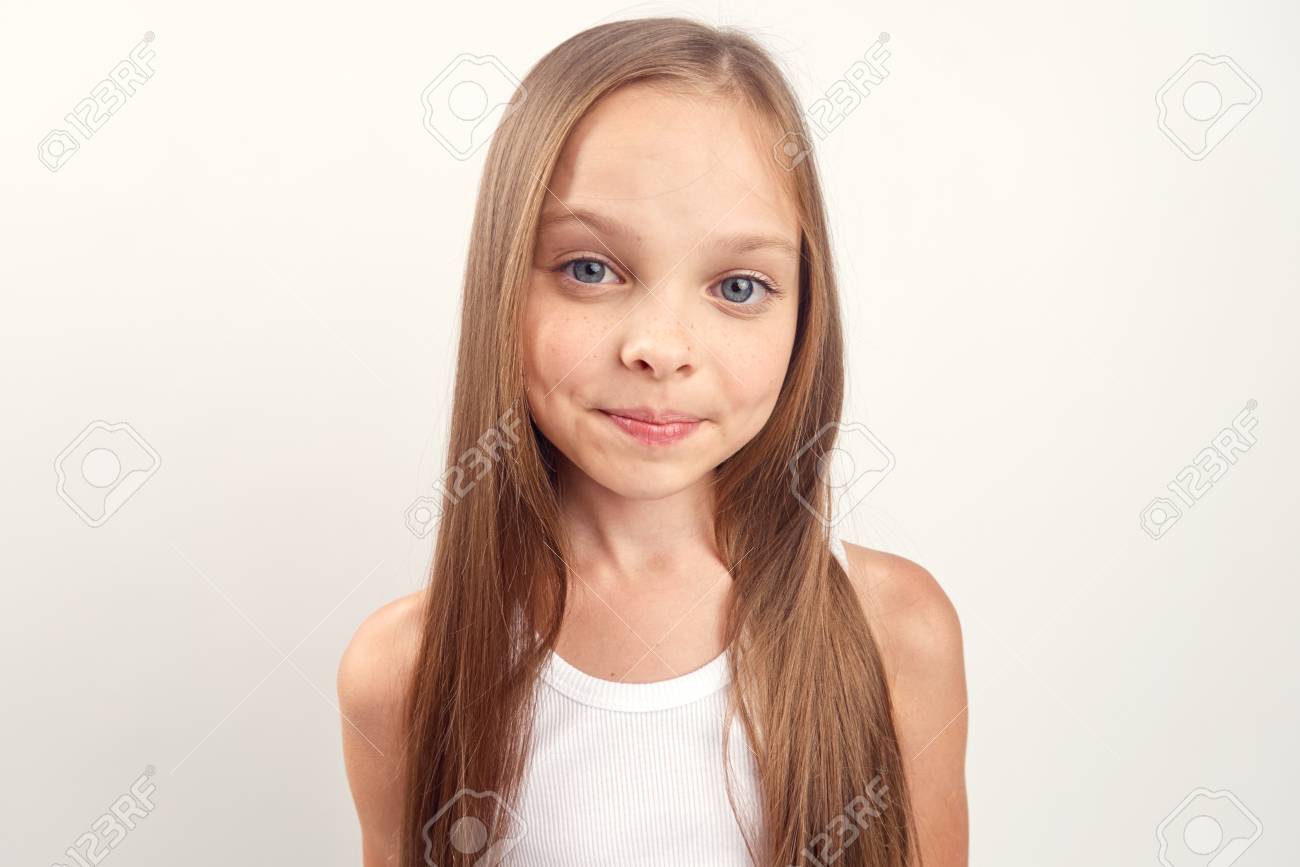 Little Girl With Long Straight Hair On A White Background Portrait