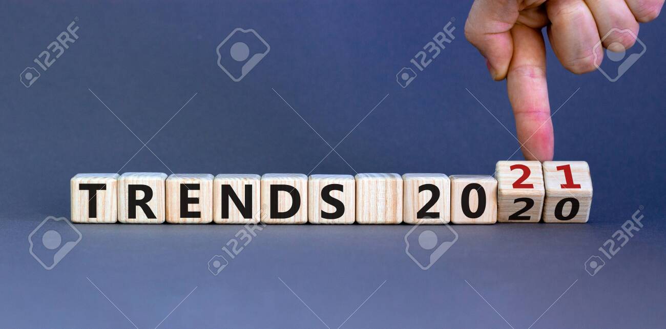 Business concept of planning 2021. Male hand flips wooden cubes and changes the inscription 'TRENDS 2020' to 'TRENDS 2021'. Beautiful gray background, copy space. - 156779110 Business concept of planning 2021. Male hand flips wooden cubes and changes the inscription 'TRENDS 2020' to 'TRENDS 2021'. Beautiful gray background, copy space. - 156779110