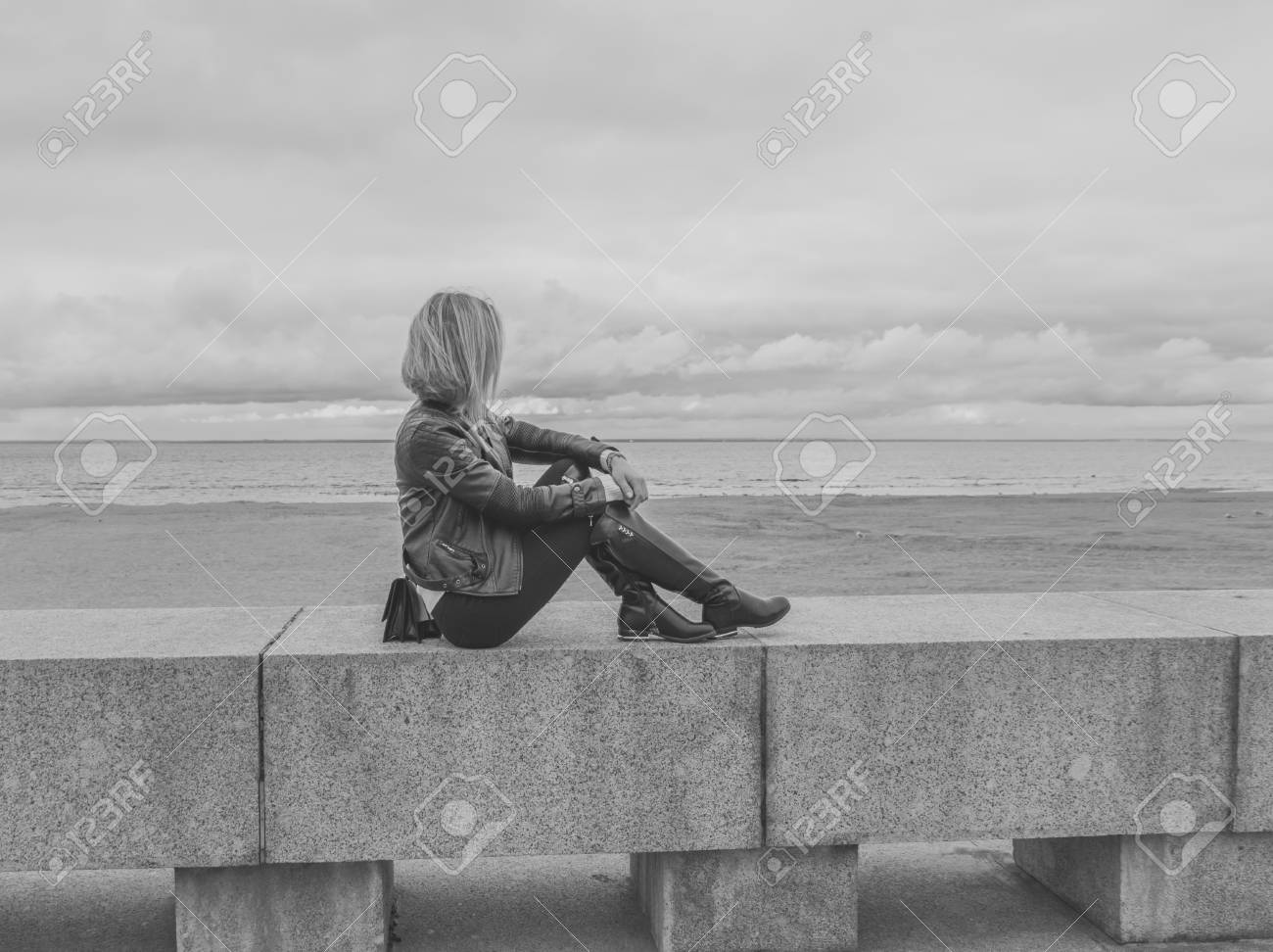 Black And White On The Stone Pavement By The Sea Sits A Girl Stock Photo Picture And Royalty Free Image Image