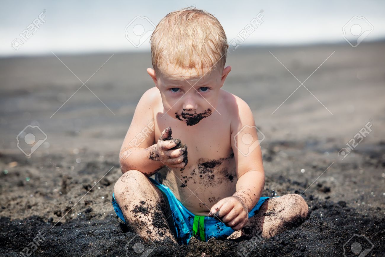 Funny Photo Of Happy Baby Boy With Dirty Body And Sly Face Playing