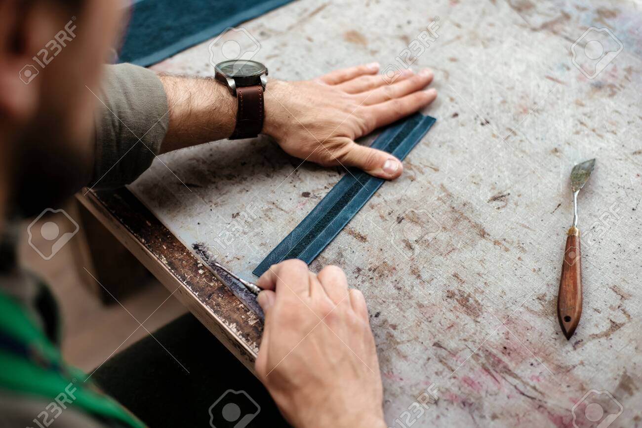 A master workes with details for future goods from natural leather - 120878596 A master workes with details for future goods from natural leather - 120878596
