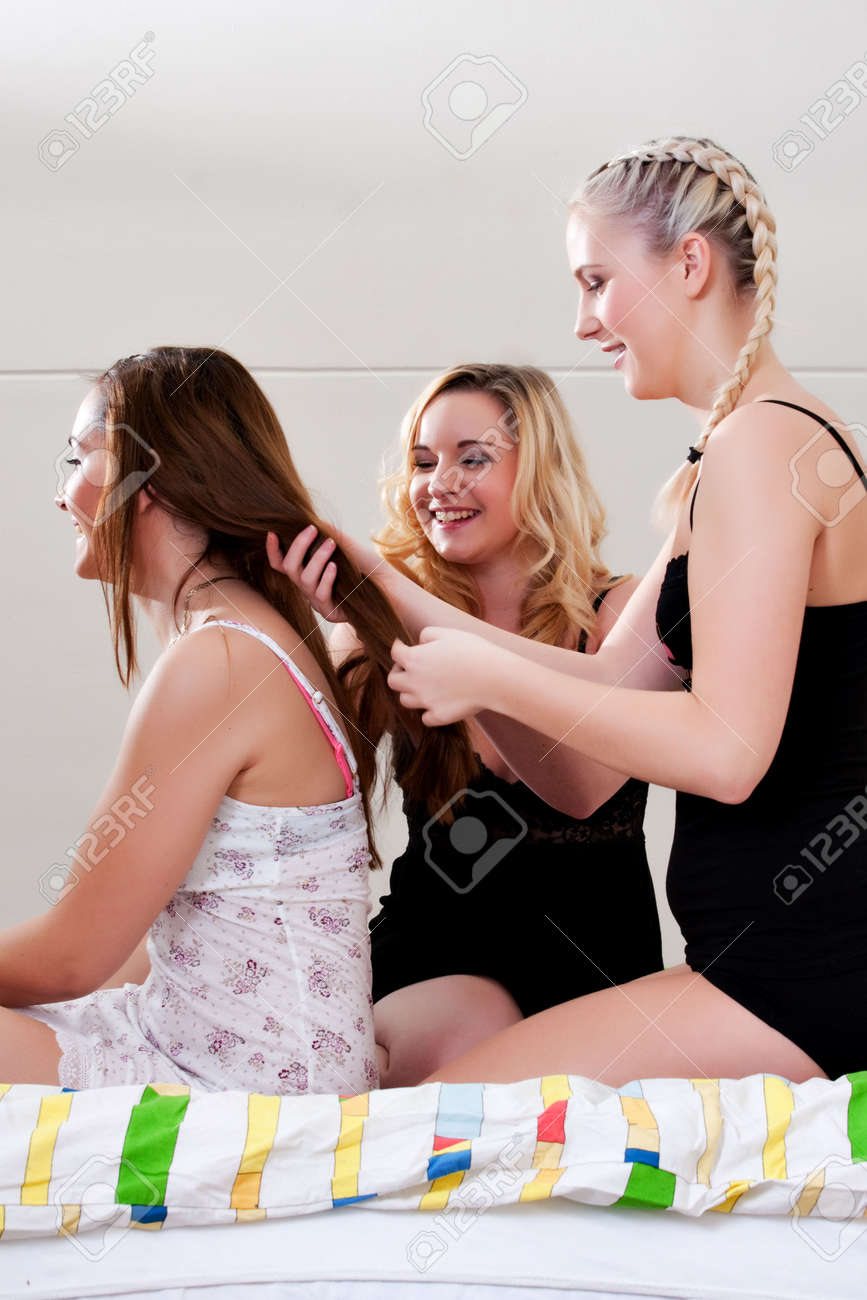 3 Friends Having A Pyjama Party In A Bedroom