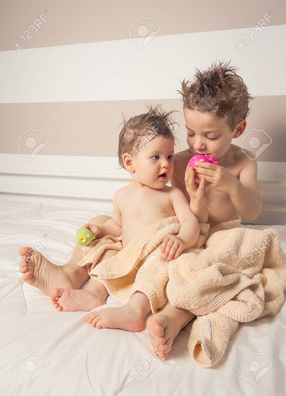 Portrait Of Sweet Boy And Little Girl With Wet Hair Under The Towels Playing Over A Bed After Bath Stock Photo, Picture And Royalty Free Image. Image 28966328. Portrait Of Sweet Boy And Little Girl With Wet Hair Under The Towels Playing Over A Bed After Bath Stock Photo, Picture And Royalty Free Image. Image 28966328.