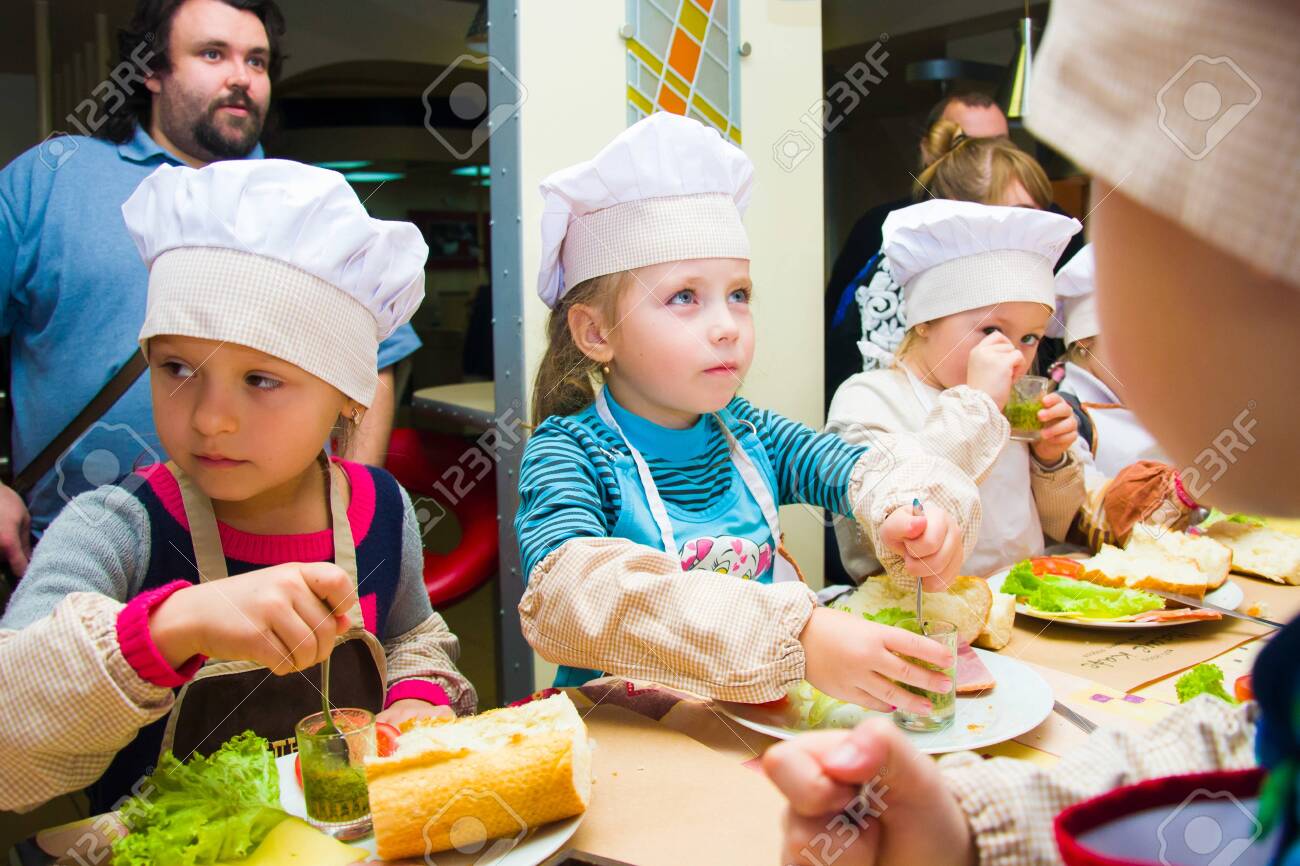 Alchevsk, Ukraine - November 8, 2018: children in the form of cooks prepare sandwiches. - 138122603 Alchevsk, Ukraine - November 8, 2018: children in the form of cooks prepare sandwiches. - 138122603