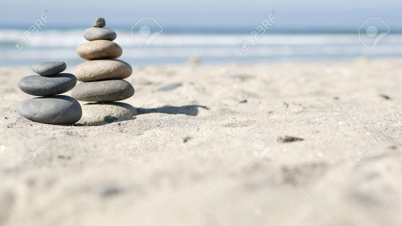 Rock balancing on ocean beach, stones stacking by sea water waves. Pyramid of pebbles on sandy shore. Stable pile or heap in soft focus with bokeh, close up. Zen balance, minimalism, harmony and peace - 169279383 Rock balancing on ocean beach, stones stacking by sea water waves. Pyramid of pebbles on sandy shore. Stable pile or heap in soft focus with bokeh, close up. Zen balance, minimalism, harmony and peace - 169279383