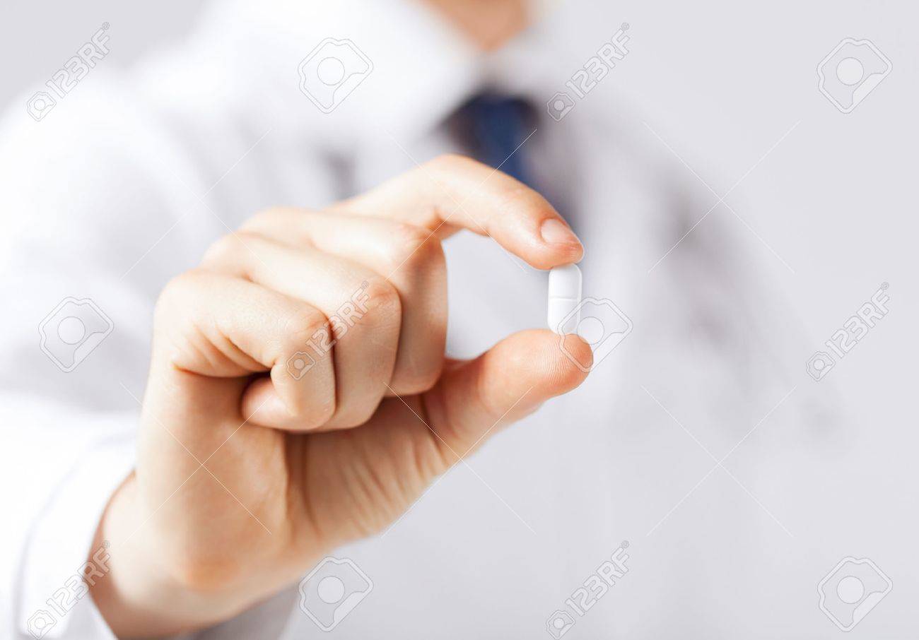 healthcare and medical concept - doctor with pill in hospital - 22185479 healthcare and medical concept - doctor with pill in hospital - 22185479