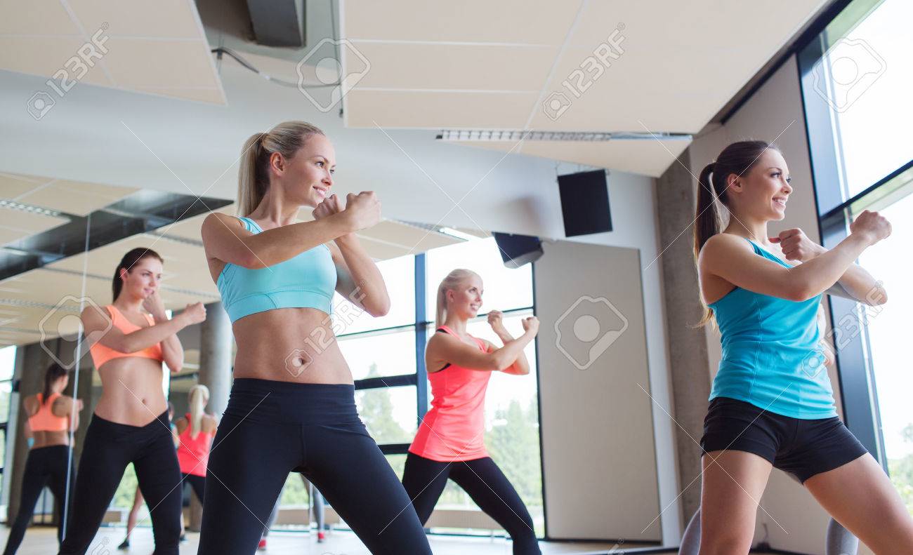 fitness, sport, people, martial arts and gym concept - group of women working out and standing in battle stance - 35289769 fitness, sport, people, martial arts and gym concept - group of women working out and standing in battle stance - 35289769