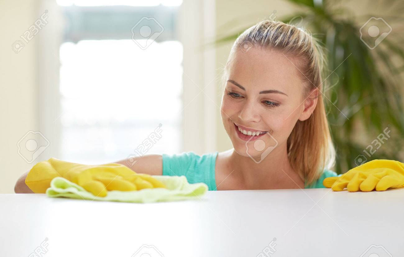 people, housework and housekeeping concept - happy woman cleaning table at home kitchen - 37055823 people, housework and housekeeping concept - happy woman cleaning table at home kitchen - 37055823