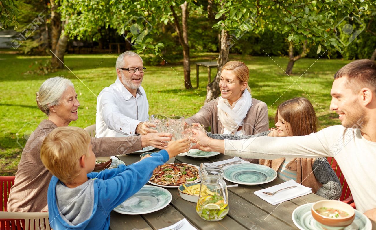 family, generation, home, holidays and people concept - happy family having dinner and clinking glasses in summer garden - 37107069 family, generation, home, holidays and people concept - happy family having dinner and clinking glasses in summer garden - 37107069