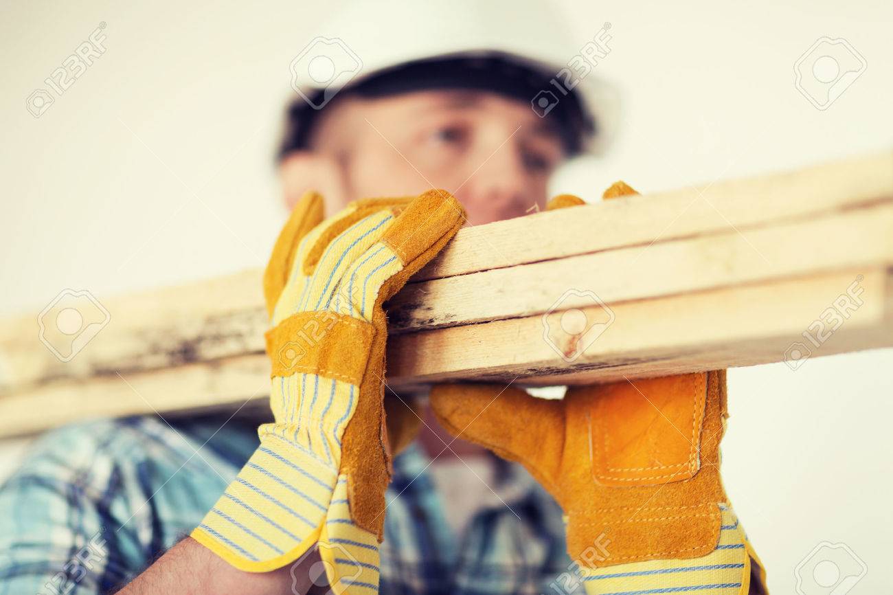 repair, building and home concept - close up of male in gloves and helmet carrying wooden boards on shoulder - 37681283 repair, building and home concept - close up of male in gloves and helmet carrying wooden boards on shoulder - 37681283