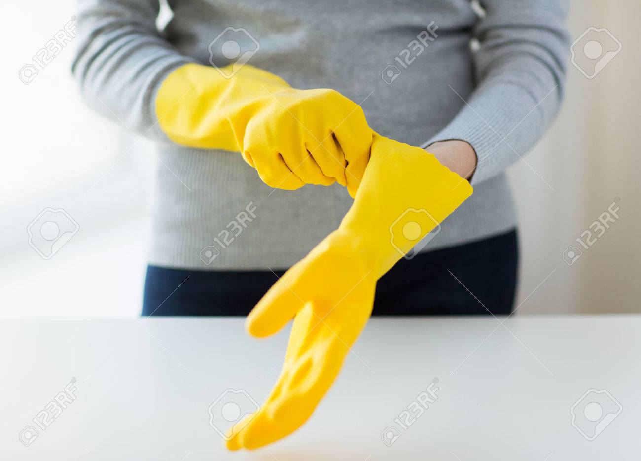 people, housework, safety and housekeeping concept - close up of woman hands wearing protective rubber gloves - 38663121 people, housework, safety and housekeeping concept - close up of woman hands wearing protective rubber gloves - 38663121