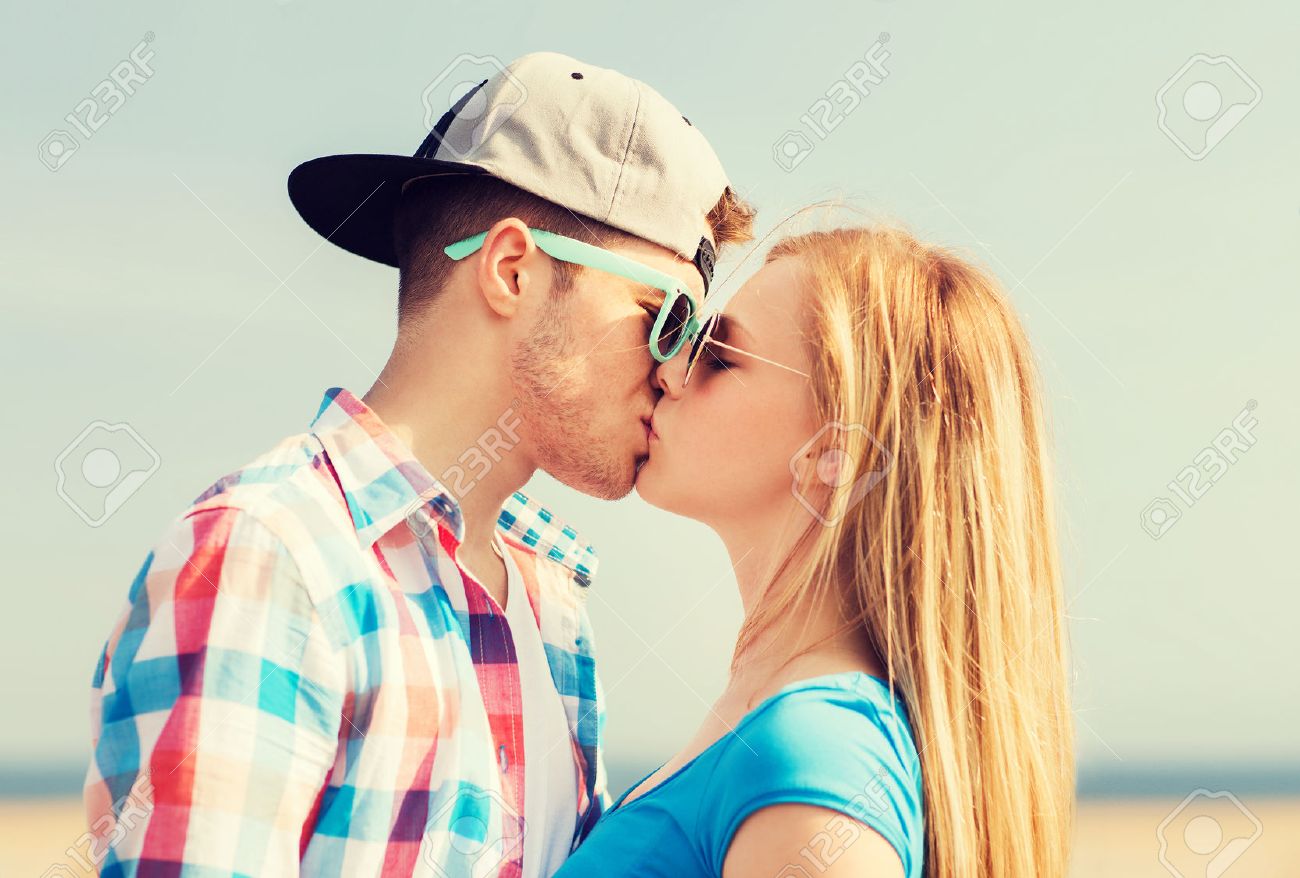 Holidays Vacation And Love Concept Teenage Couple Kissing