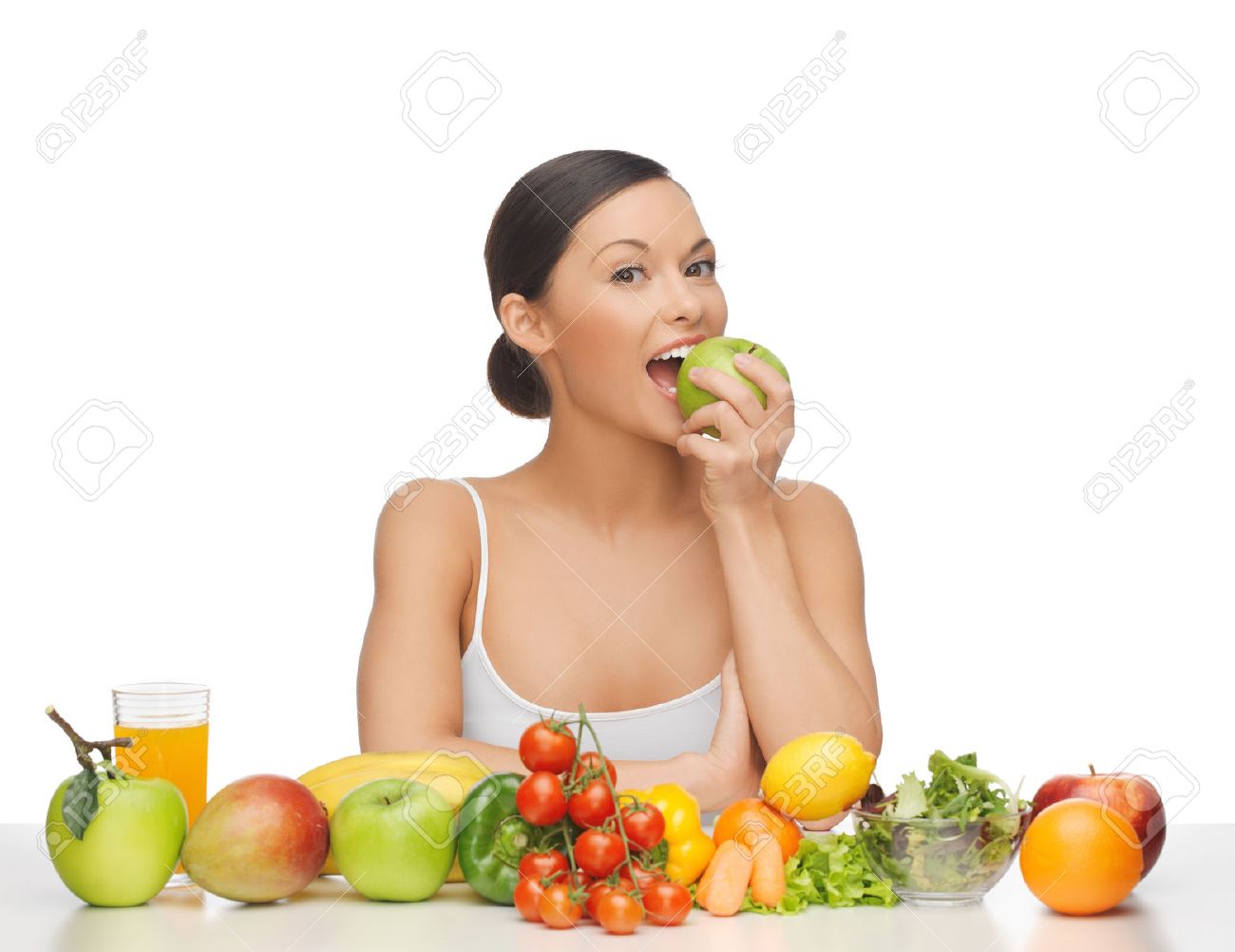 woman eating apple with lot of fruits and vegetables - 50154806 woman eating apple with lot of fruits and vegetables - 50154806