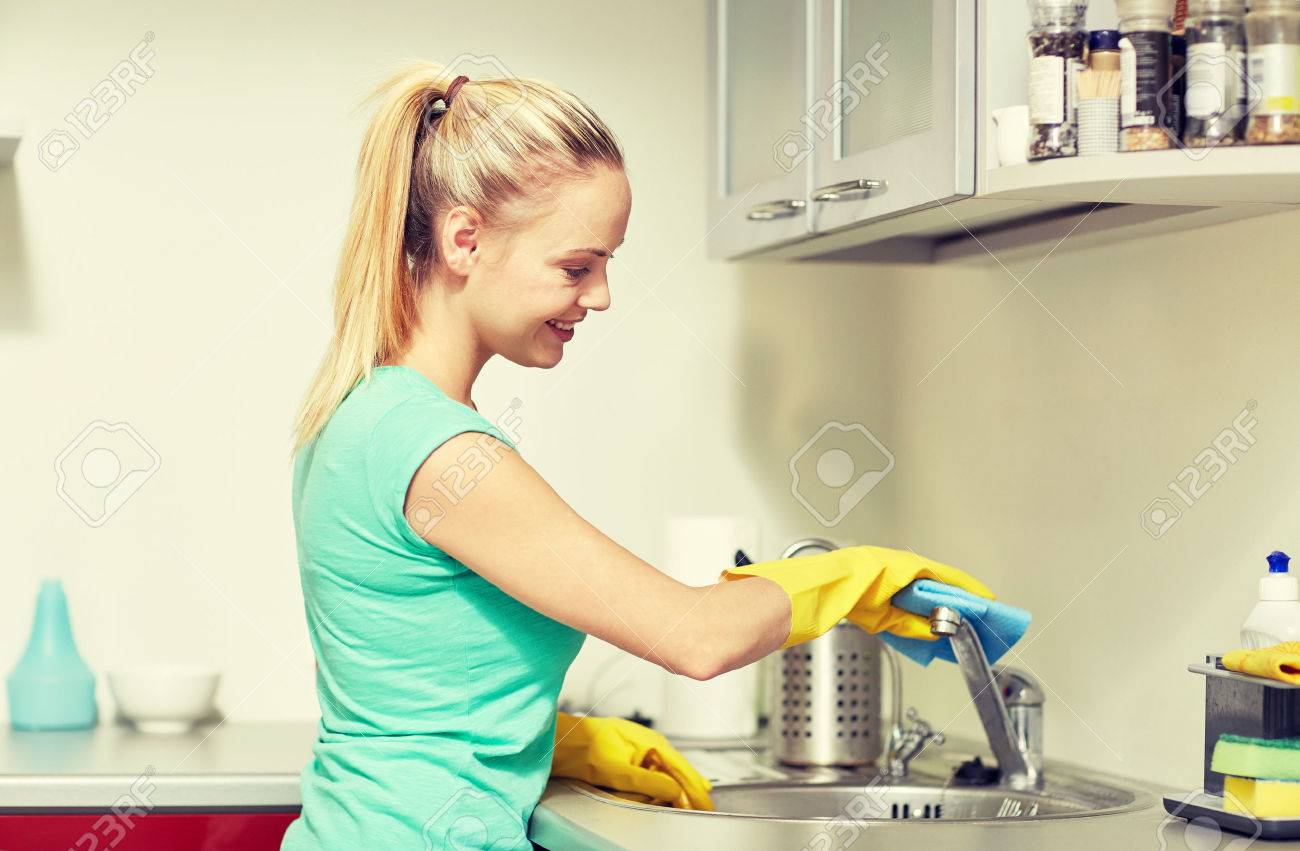 people, housework and housekeeping concept - happy woman in protective gloves cleaning tap with rag at home kitchen - 50944546 people, housework and housekeeping concept - happy woman in protective gloves cleaning tap with rag at home kitchen - 50944546