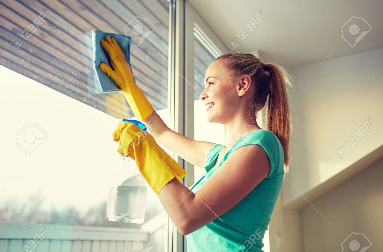 people, housework and housekeeping concept - happy woman in gloves cleaning window with rag and cleanser spray at home - 51129854 people, housework and housekeeping concept - happy woman in gloves cleaning window with rag and cleanser spray at home - 51129854