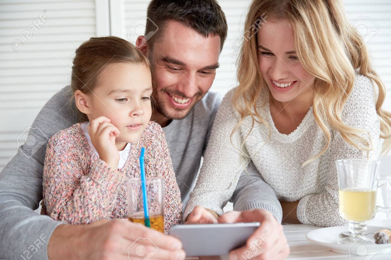 family, parenthood, technology and people concept - happy mother, father and little girl with smartphone having dinner at restaurant - 51334603 family, parenthood, technology and people concept - happy mother, father and little girl with smartphone having dinner at restaurant - 51334603