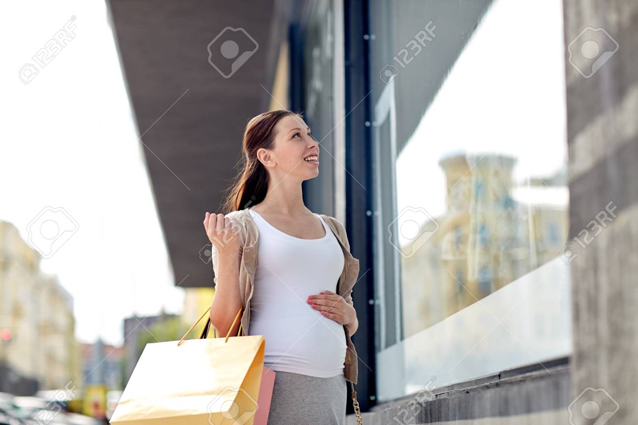 pregnancy, motherhood, people and expectation concept - happy smiling pregnant woman with shopping bags at city street - 51942255 pregnancy, motherhood, people and expectation concept - happy smiling pregnant woman with shopping bags at city street - 51942255