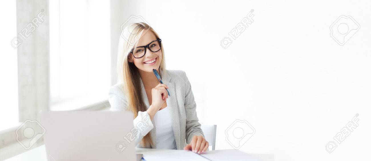 business and education concept - indoor picture of smiling woman with documents and pen - 52256707 business and education concept - indoor picture of smiling woman with documents and pen - 52256707